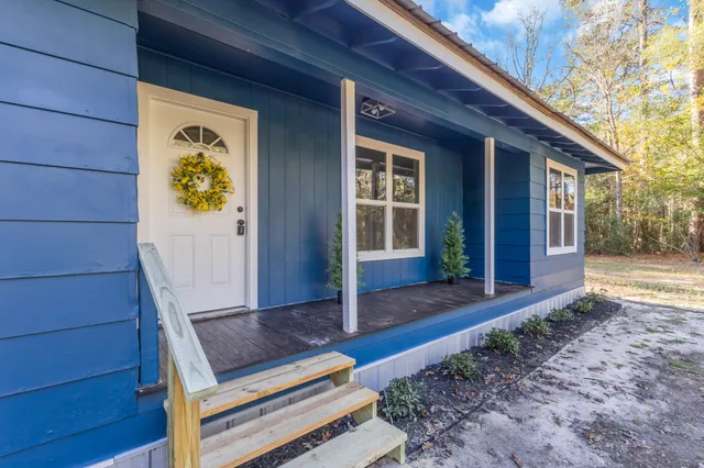 a view of house with wooden floor and wooden fence