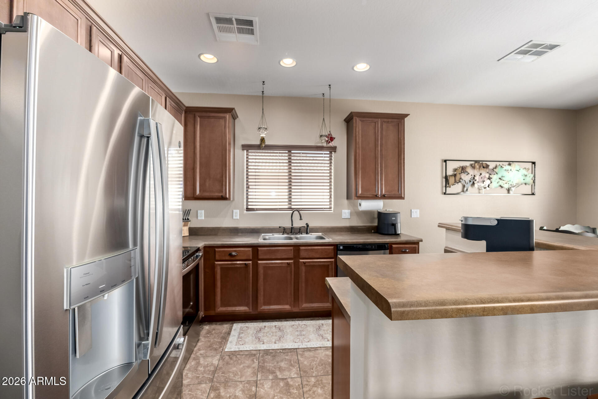 2756 South Powell Road Apache Junction, AZ 85119 - Photo 9 of 37 a kitchen with stainless steel appliances granite countertop a sink stove and refrigerator