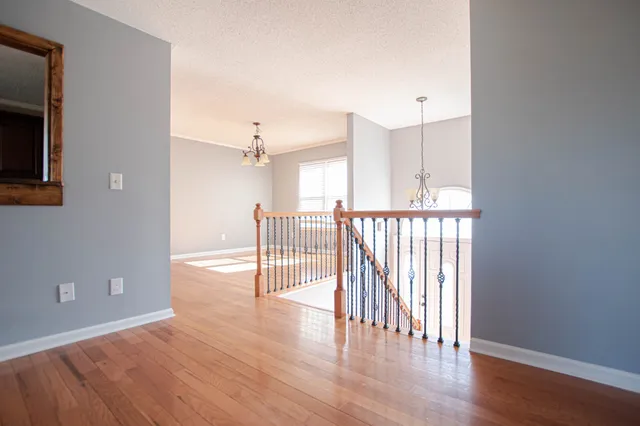 a view of a room with wooden floor