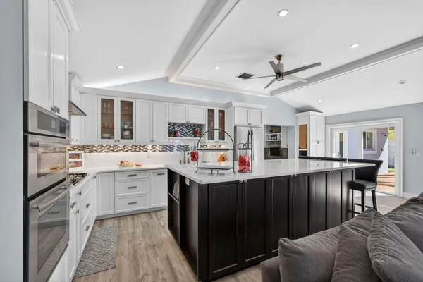 a kitchen with stainless steel appliances a stove a sink and cabinets