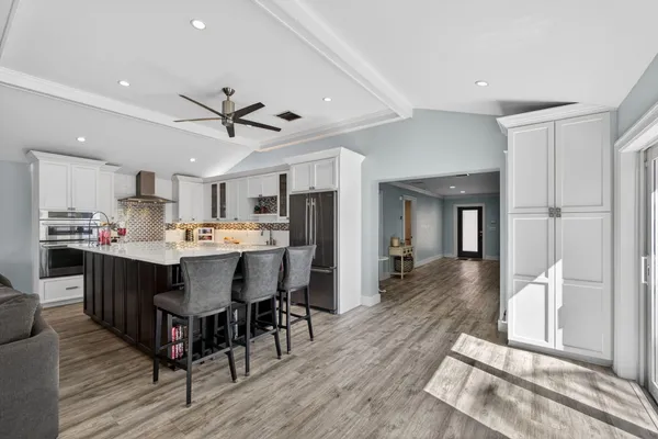 a kitchen with stainless steel appliances white cabinets and a window