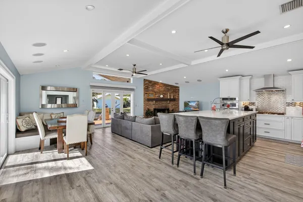 a living room with furniture ceiling fan and a wooden floor