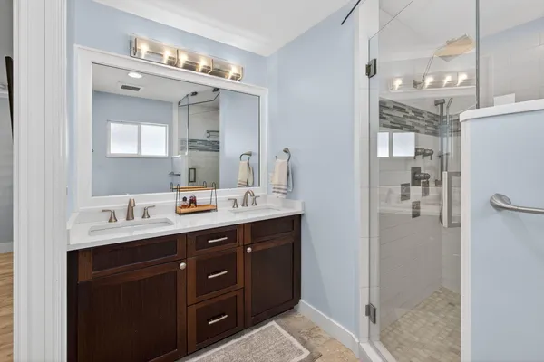 a bathroom with a sink a toilet and shower