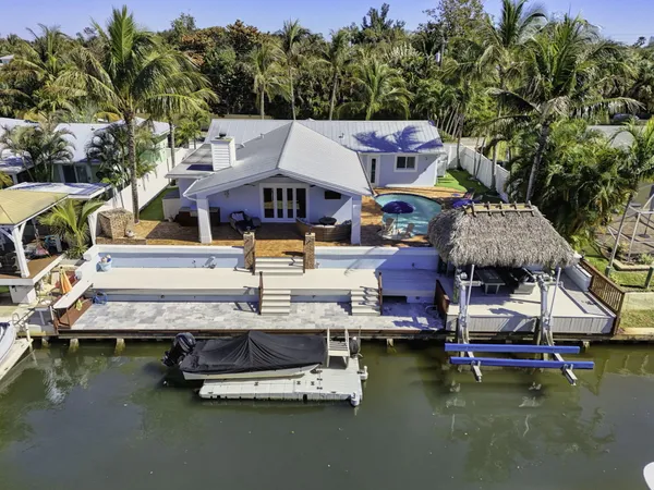 a aerial view of a house with swimming pool and outdoor seating