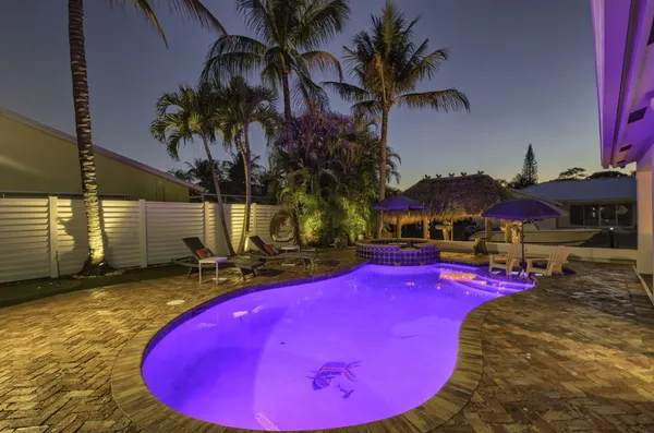 a view of a patio with couches and table and chairs with wooden floor