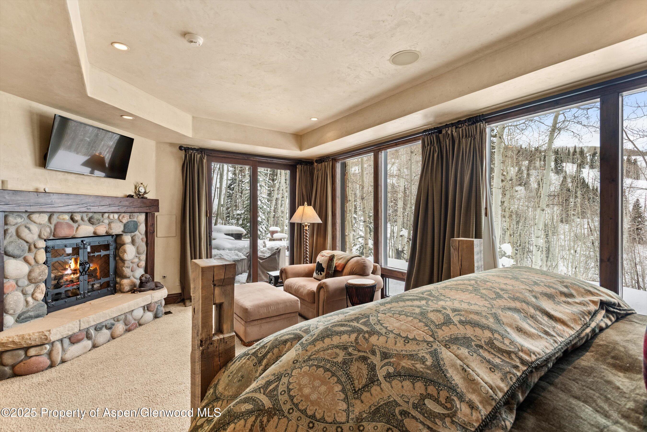 1777 Wood Road Snowmass Village, CO 81615 - Photo 17 of 27 a large bedroom with a large bed and a large window