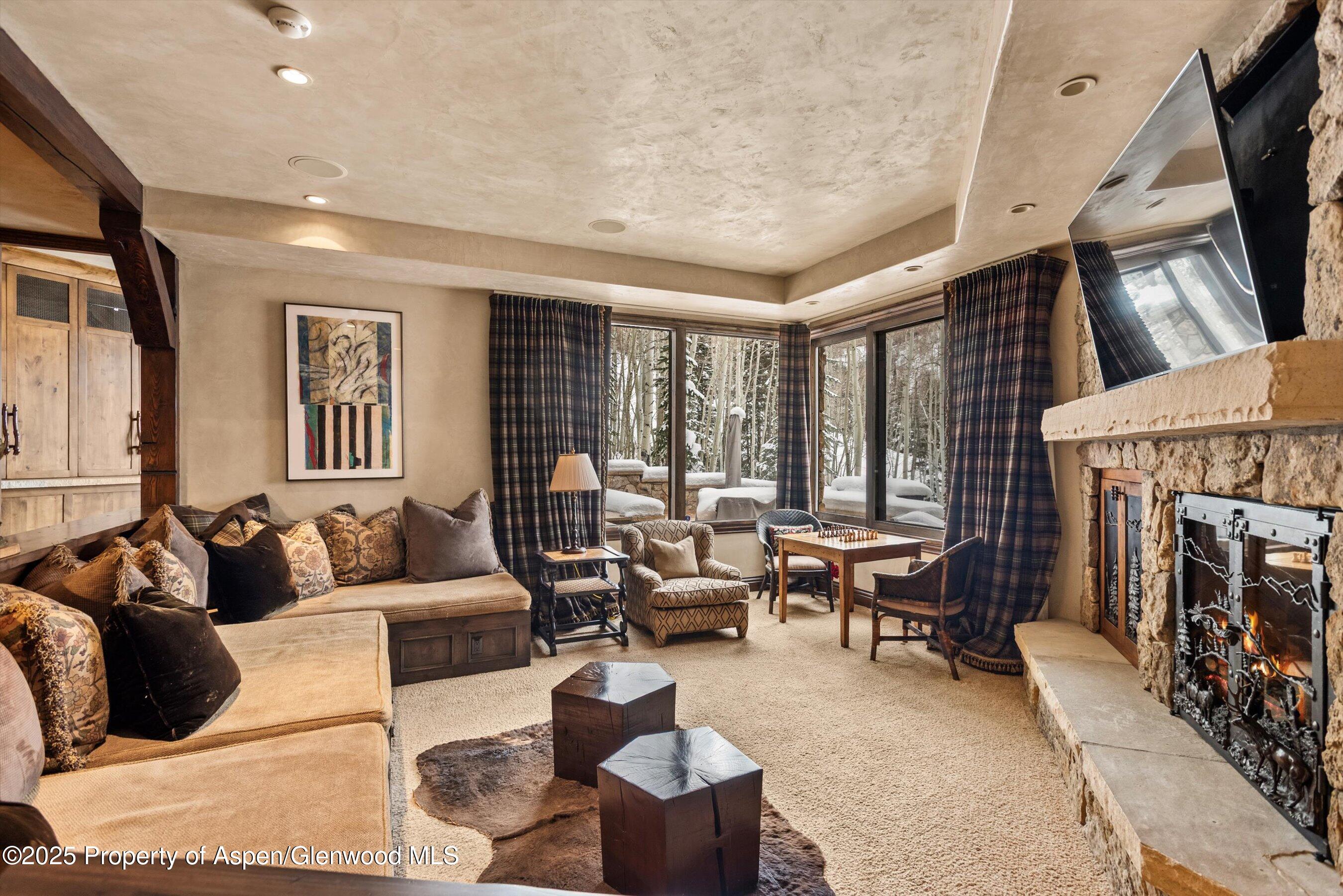 1777 Wood Road Snowmass Village, CO 81615 - Photo 19 of 27 a living room with furniture and a fireplace