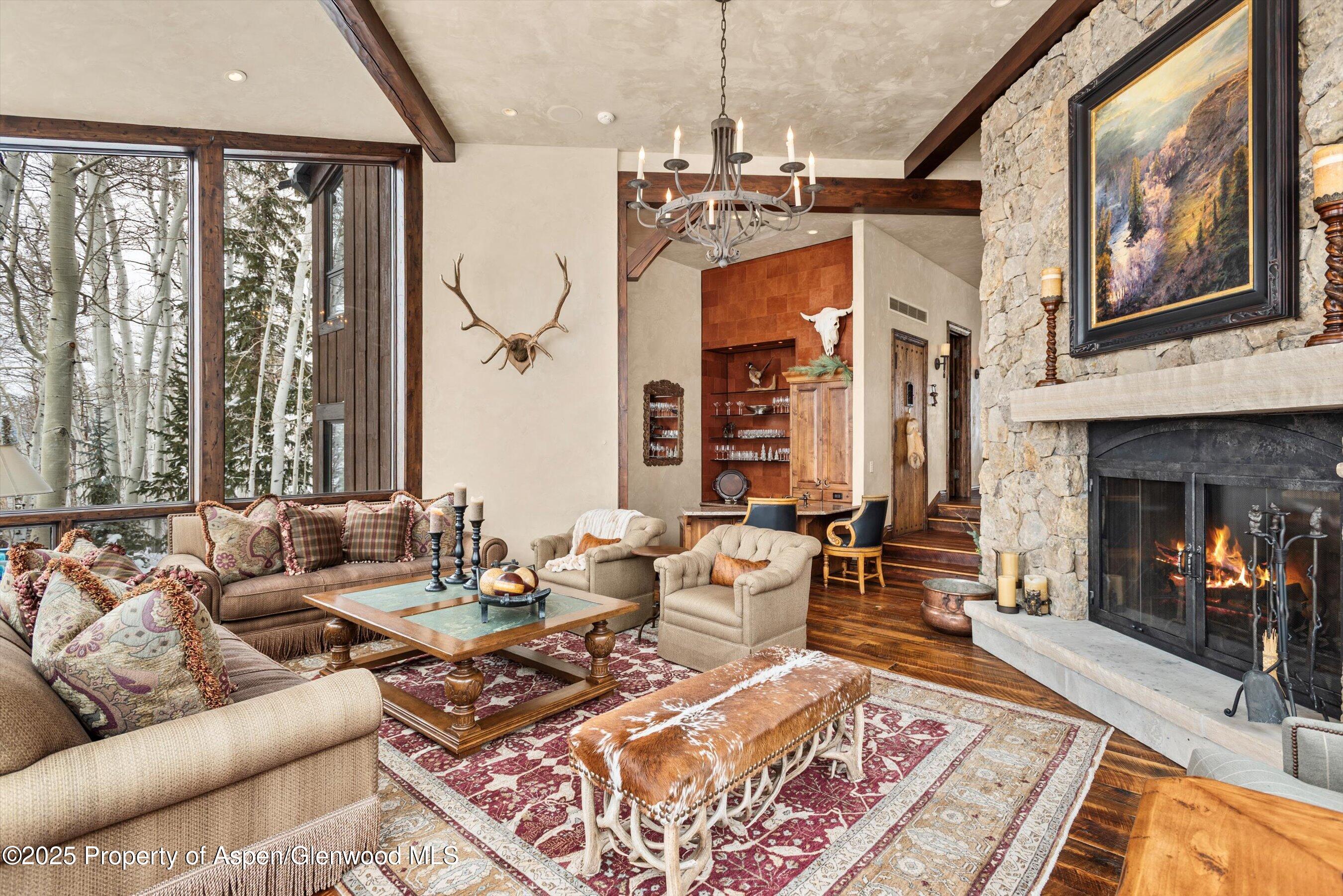 1777 Wood Road Snowmass Village, CO 81615 - Photo 2 of 27 a living room with furniture and a fireplace