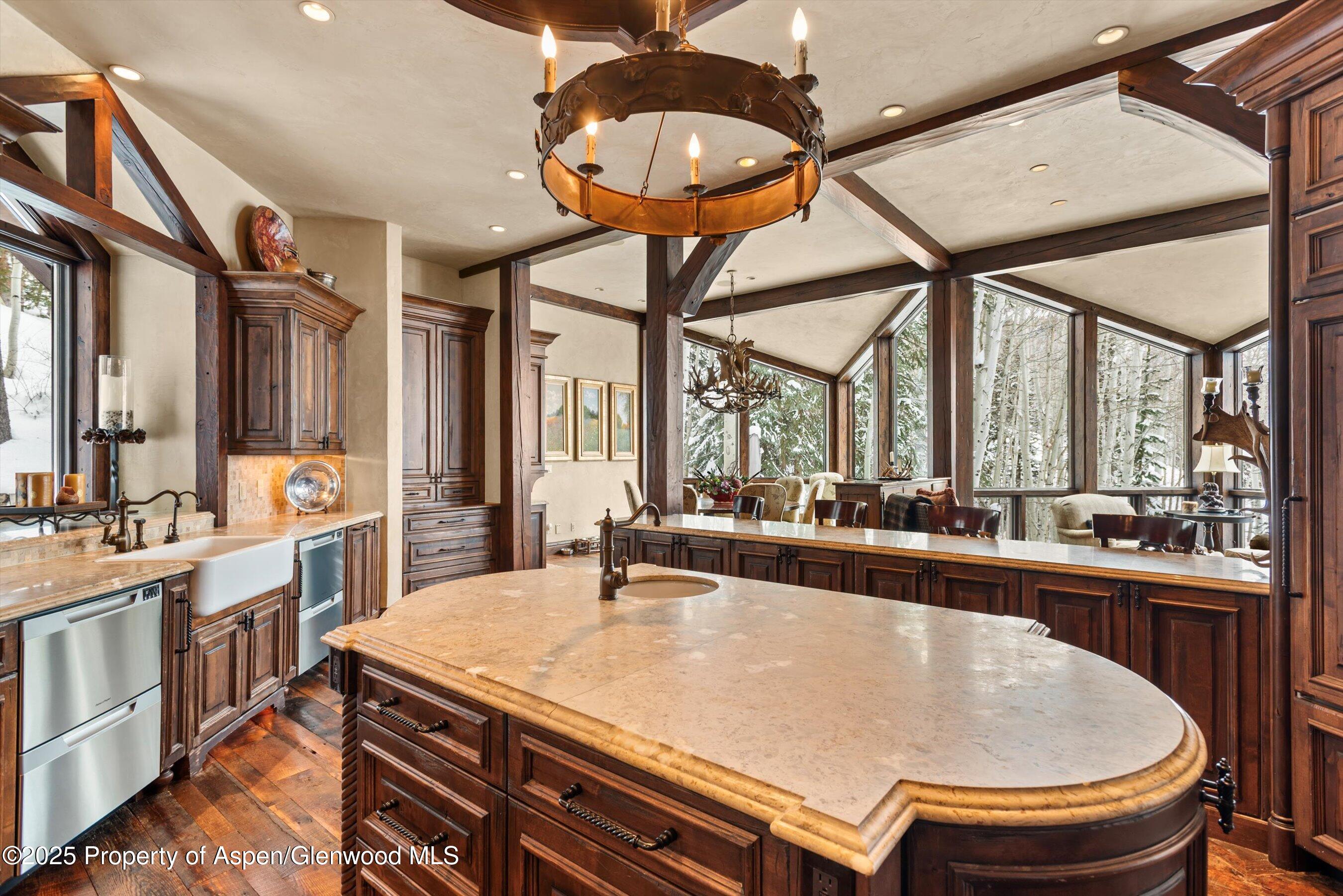 1777 Wood Road Snowmass Village, CO 81615 - Photo 4 of 27 a room with furniture a large window and chandelier