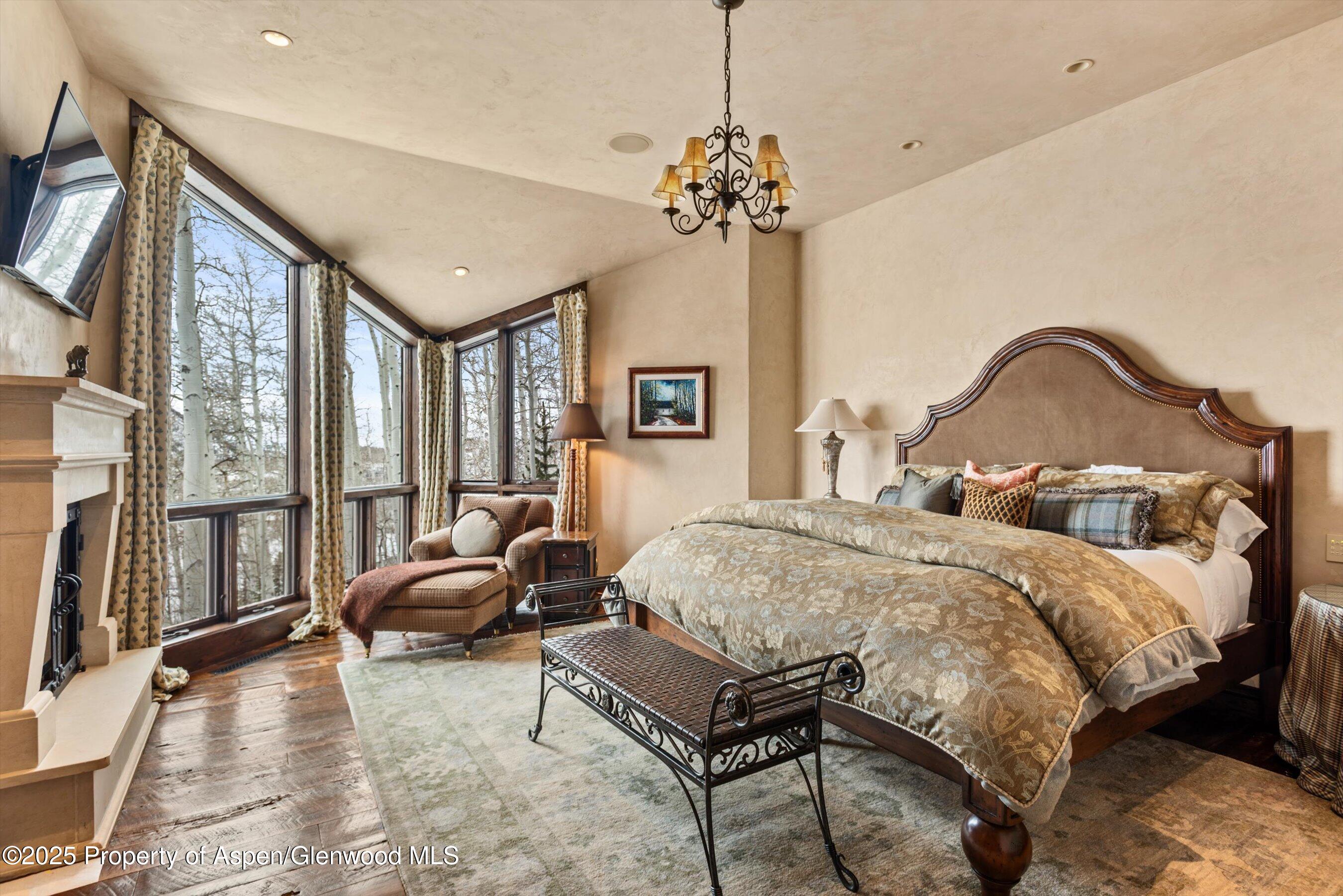 1777 Wood Road Snowmass Village, CO 81615 - Photo 9 of 27 a spacious bedroom with a bed window and couch