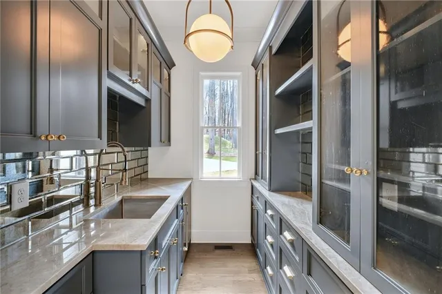 a kitchen with stainless steel appliances granite countertop a sink and a refrigerator
