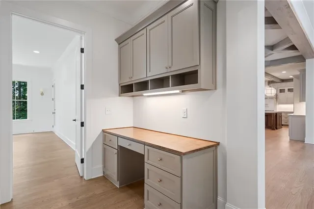 a view of a kitchen with white cabinets