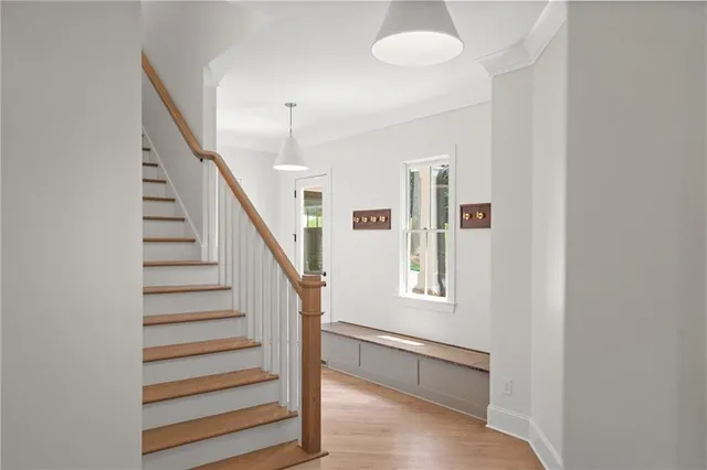 a view of entryway with wooden floor and stairs