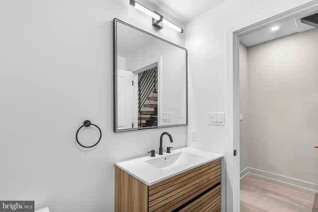 a bathroom with a sink vanity and a mirror