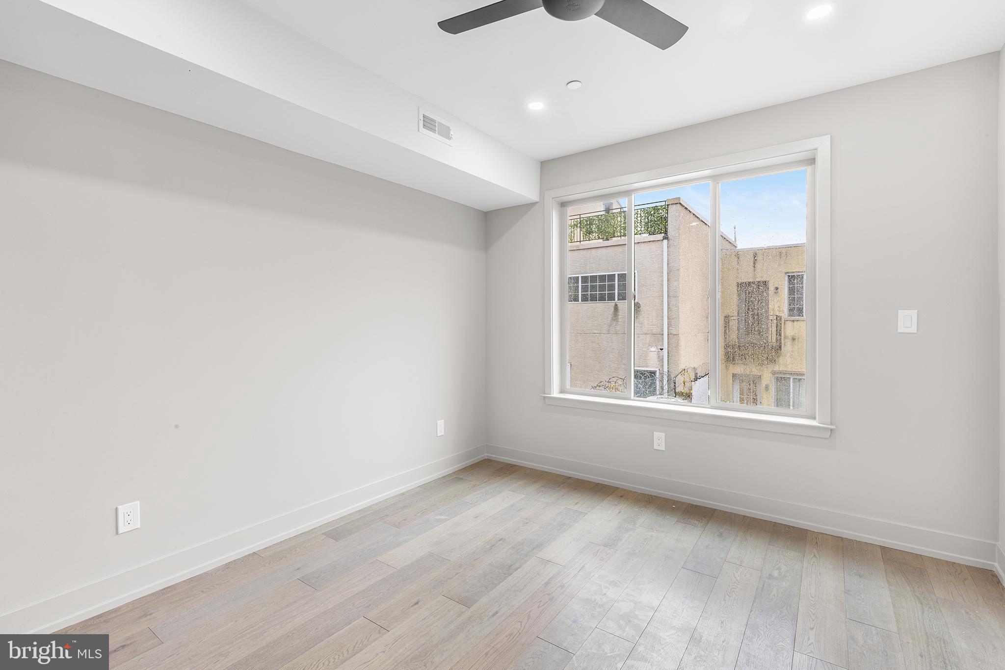 2340 Alter Street Philadelphia, PA 19146 - Photo 19 of 46 a view of an empty room with a window and wooden floor