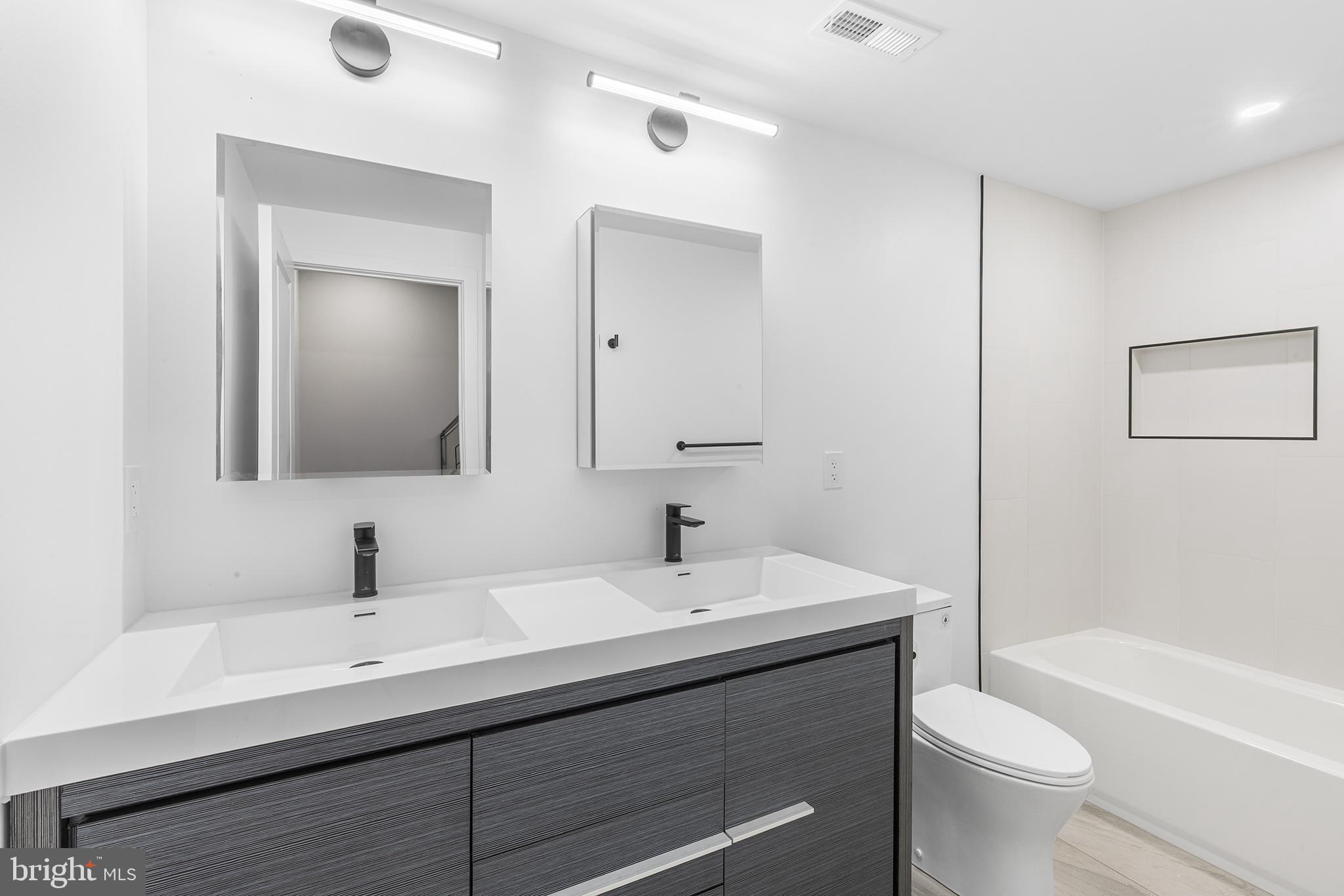 2340 Alter Street Philadelphia, PA 19146 - Photo 20 of 46 a bathroom with a toilet a sink and mirror