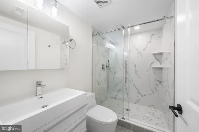 a bathroom with a sink toilet and shower