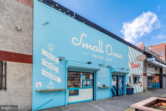 a view of a street with retail shops