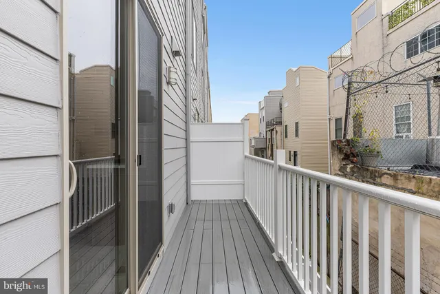a view of a balcony with wooden floor
