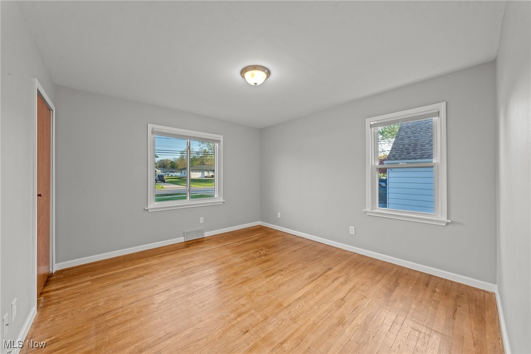 6315 Brookside Road Independence, OH 44131 - Photo 20 of 41 Unfurnished room featuring baseboards, visible vents, plenty of natural light, and light wood-style flooring