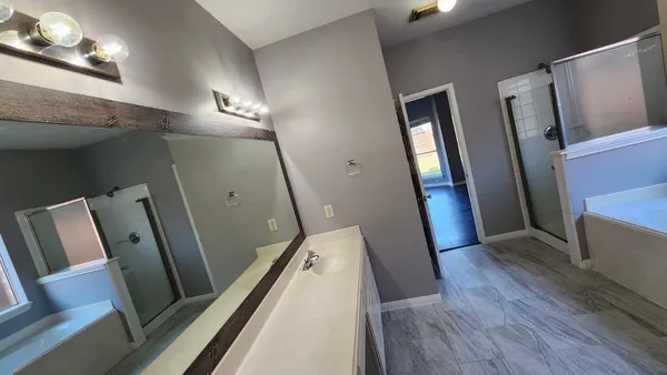a view of a hallway with wooden floor and stairs