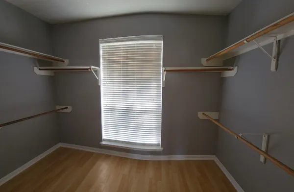 a view of a room with rack on the wall and a window