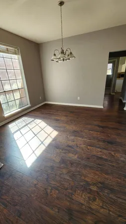 a view of a livingroom with a ceiling fan and window
