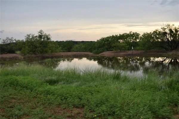 a view of a lake with houses in back