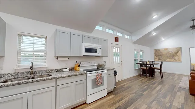 a kitchen with a sink and wooden cabinets