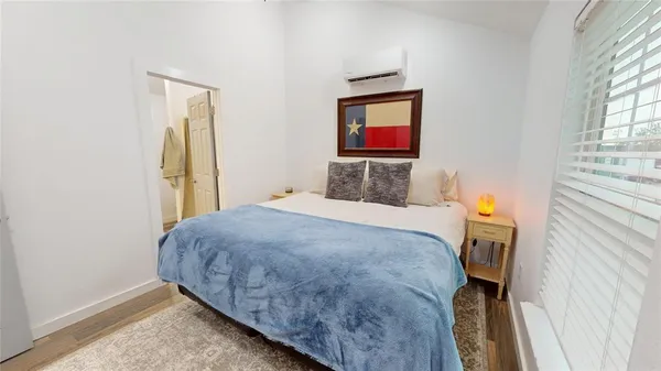 a bedroom with a bed and a flat screen tv