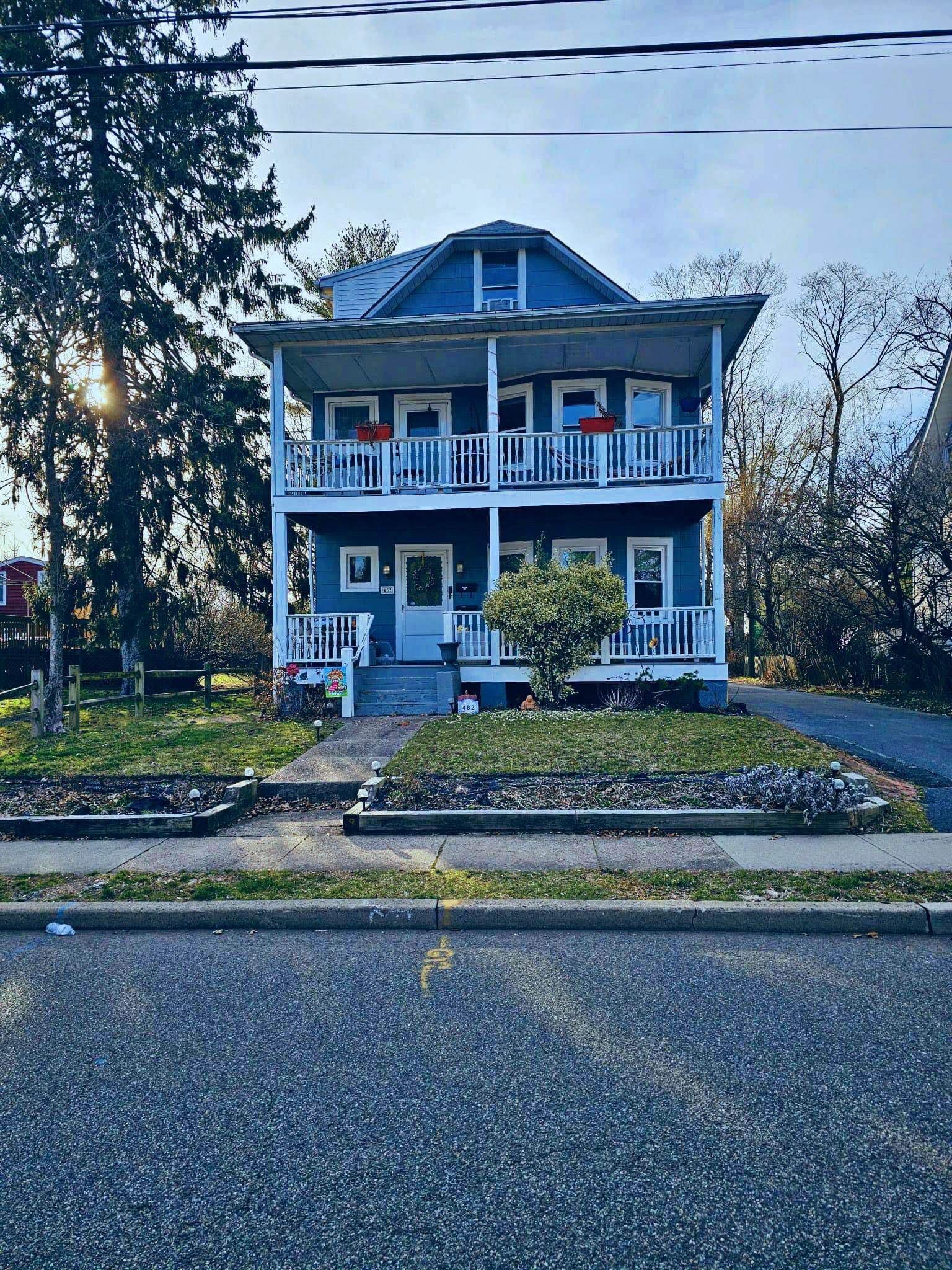 482 Sterling Place, Unit 2 Ridgewood, NJ 07450 - Photo 1 of 15 a front view of a house with a yard