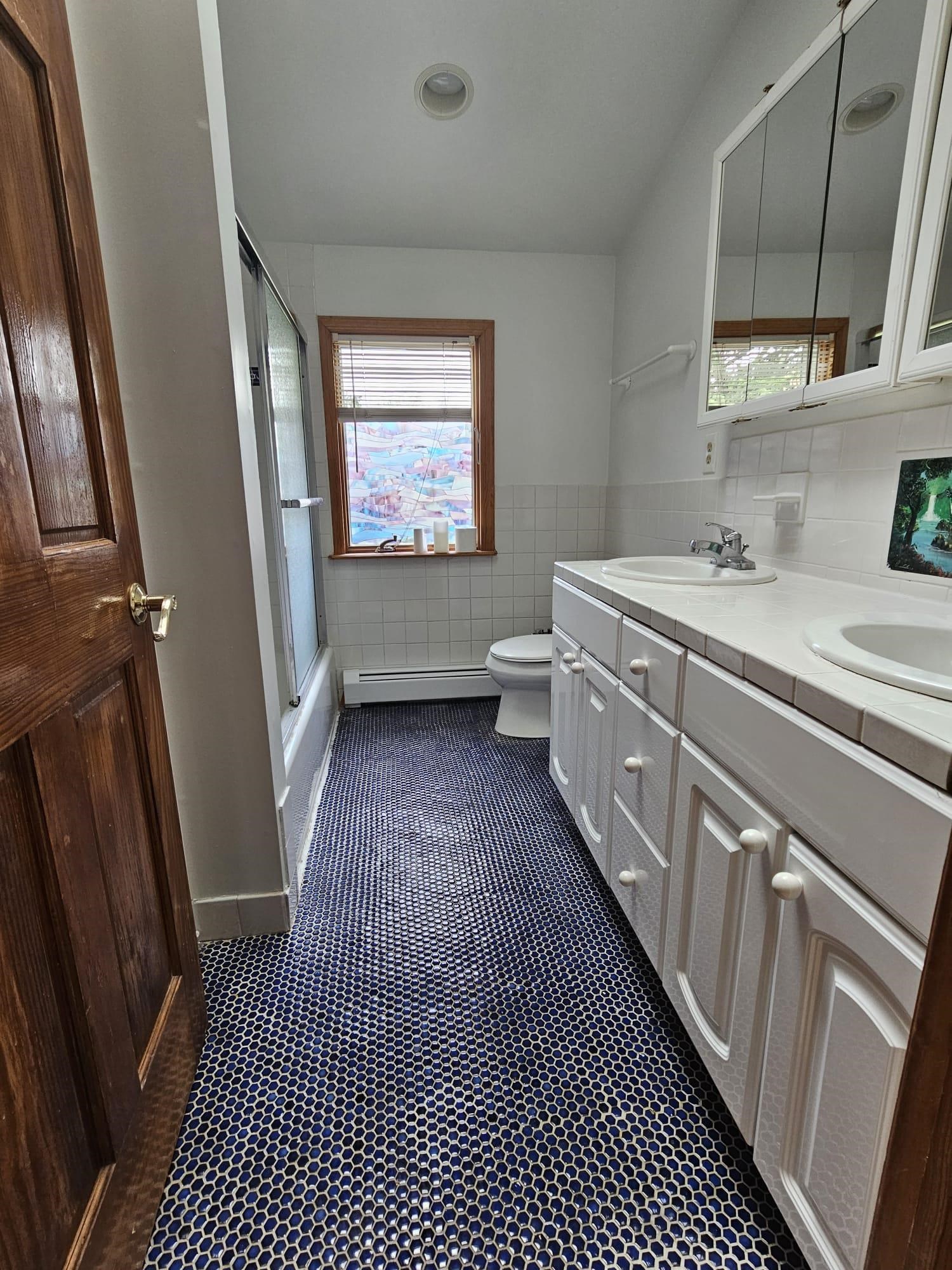 482 Sterling Place, Unit 2 Ridgewood, NJ 07450 - Photo 15 of 15 a bathroom with a sink a toilet a window and vanity