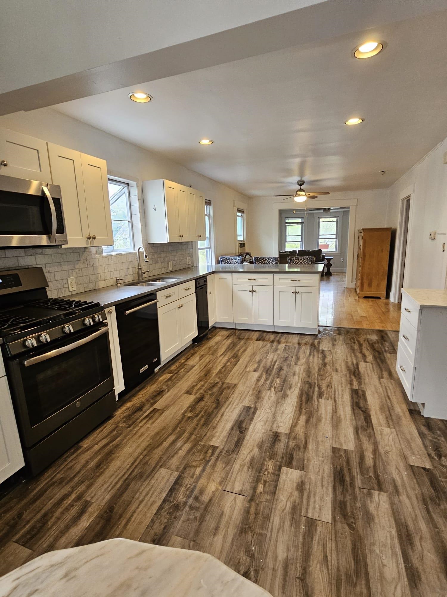 482 Sterling Place, Unit 2 Ridgewood, NJ 07450 - Photo 5 of 15 a large kitchen with stainless steel appliances granite countertop a lot of counter space and wooden floors