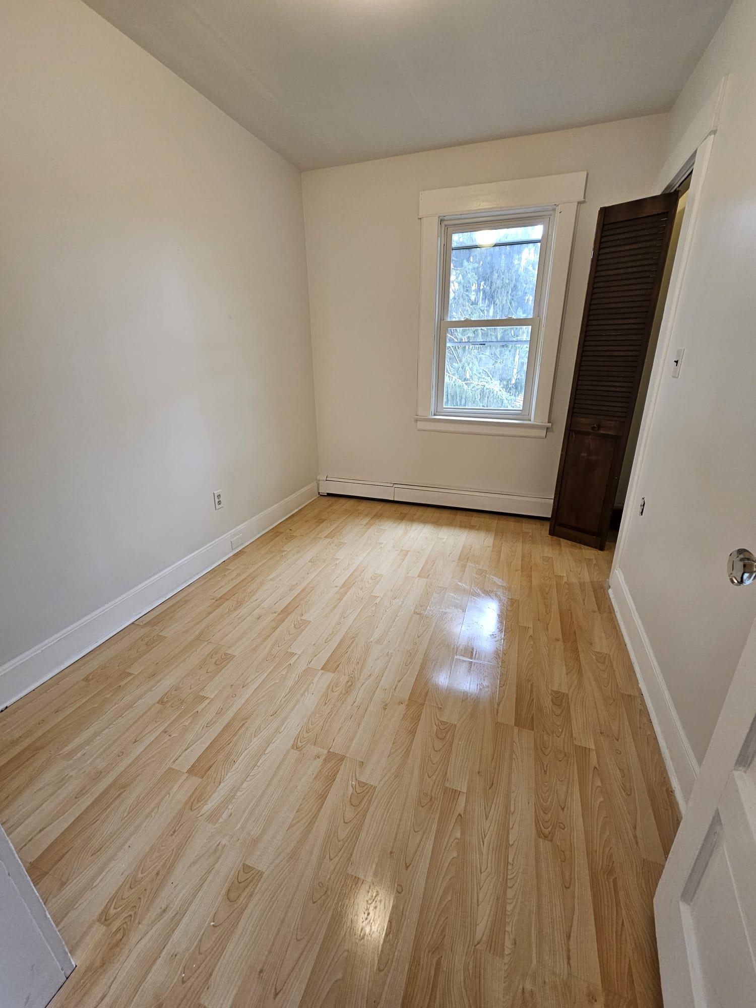 482 Sterling Place, Unit 2 Ridgewood, NJ 07450 - Photo 9 of 15 an empty room with wooden floor and windows