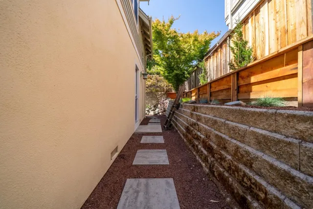a view of a pathway of a house with a yard