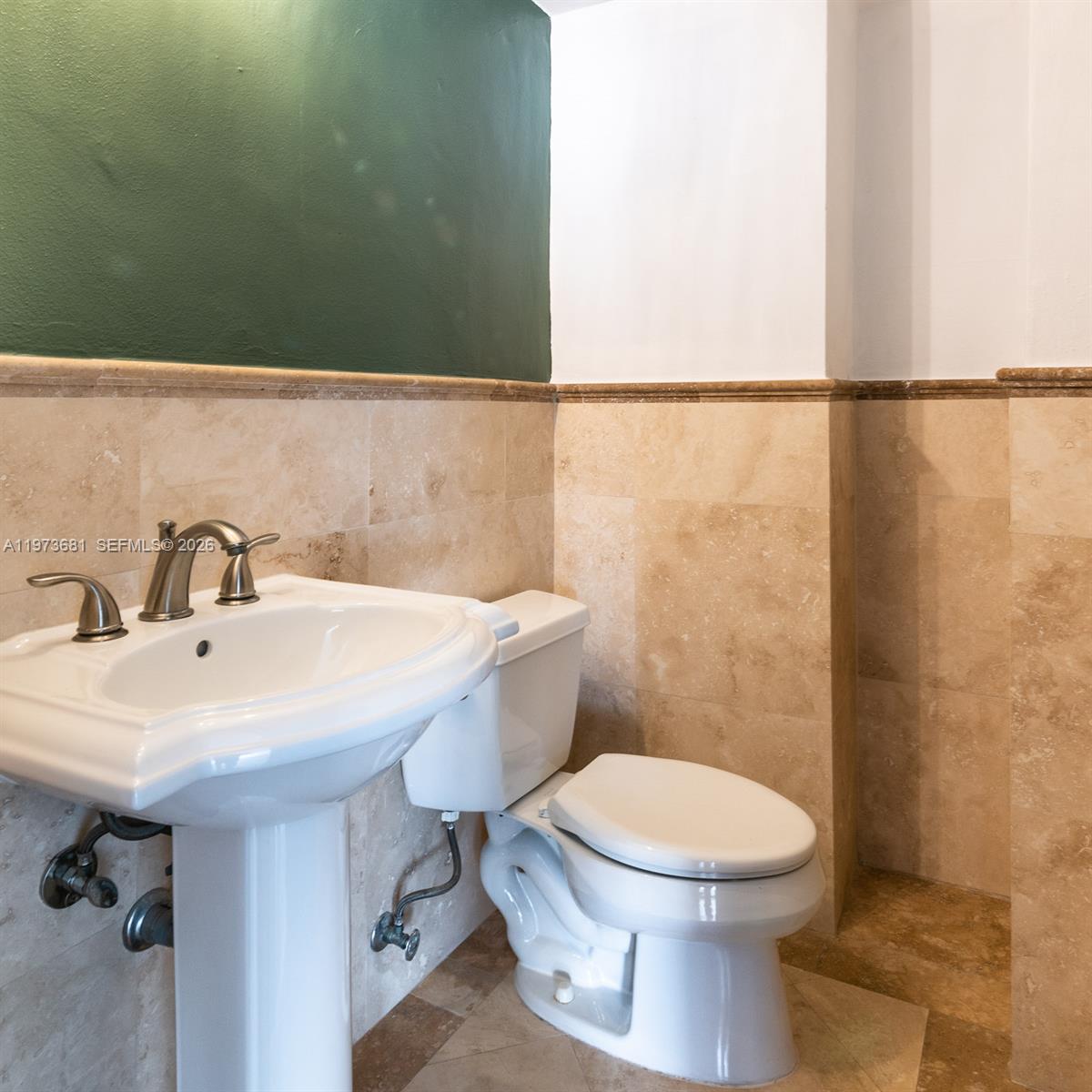 9225 Collins Avenue, Unit 1010 Surfside, FL 33154 - Photo 11 of 25 a bathroom with a sink a toilet and mirror