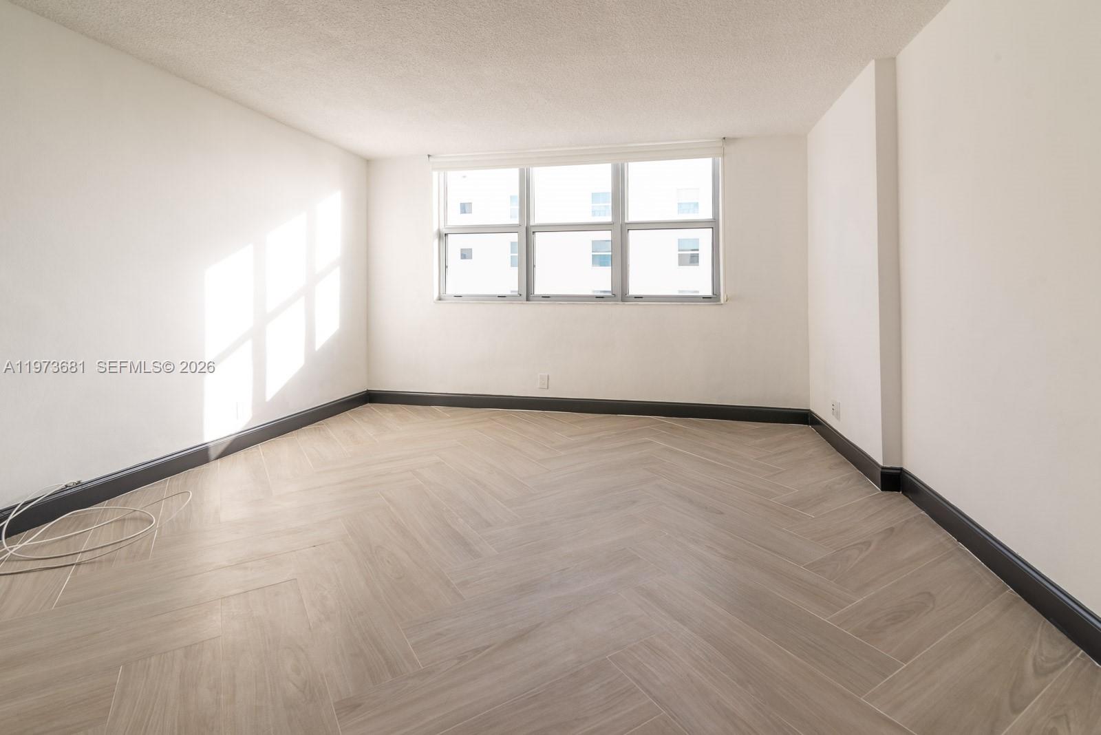 9225 Collins Avenue, Unit 1010 Surfside, FL 33154 - Photo 12 of 25 an empty room with windows