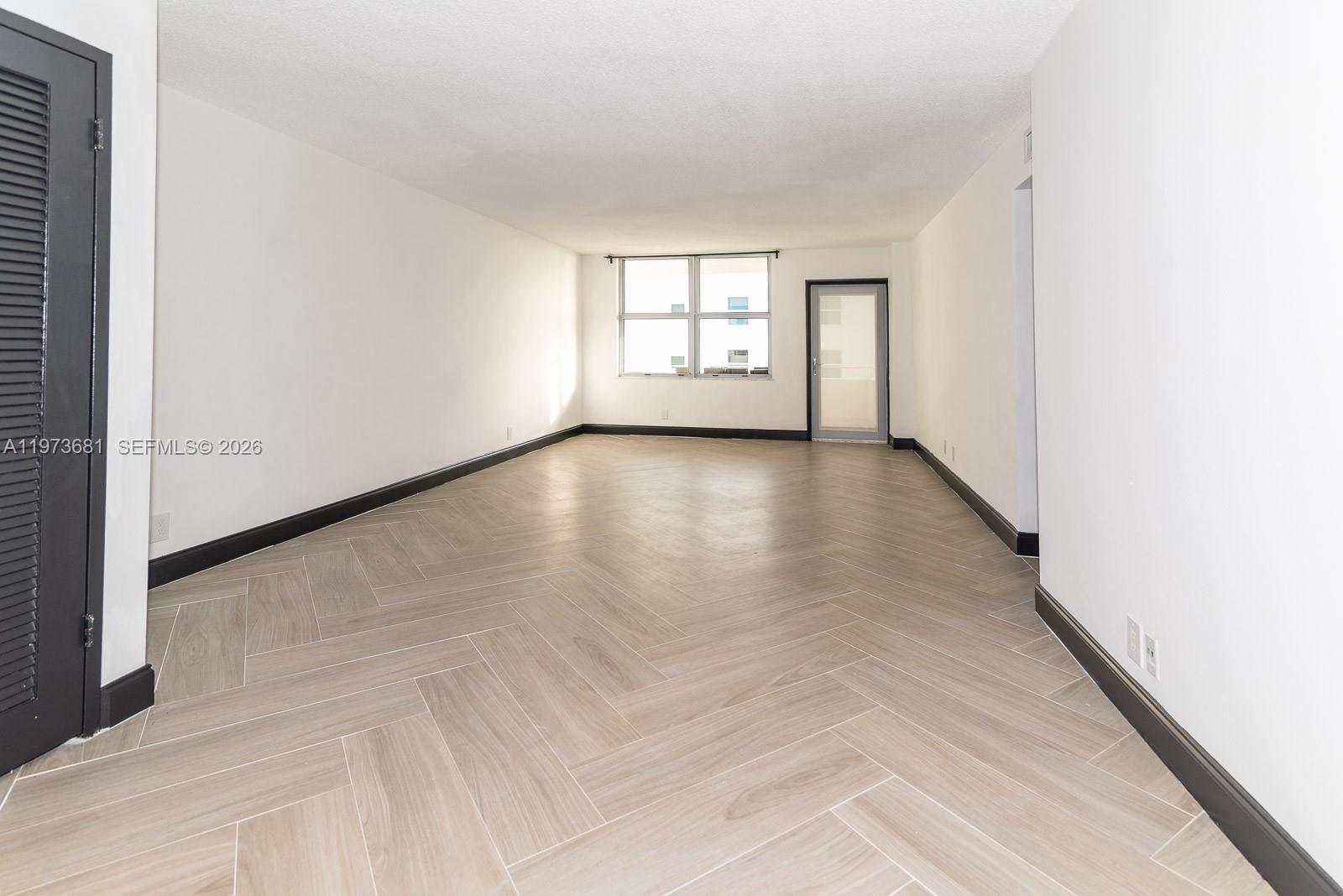 9225 Collins Avenue, Unit 1010 Surfside, FL 33154 - Photo 13 of 25 an empty room with windows