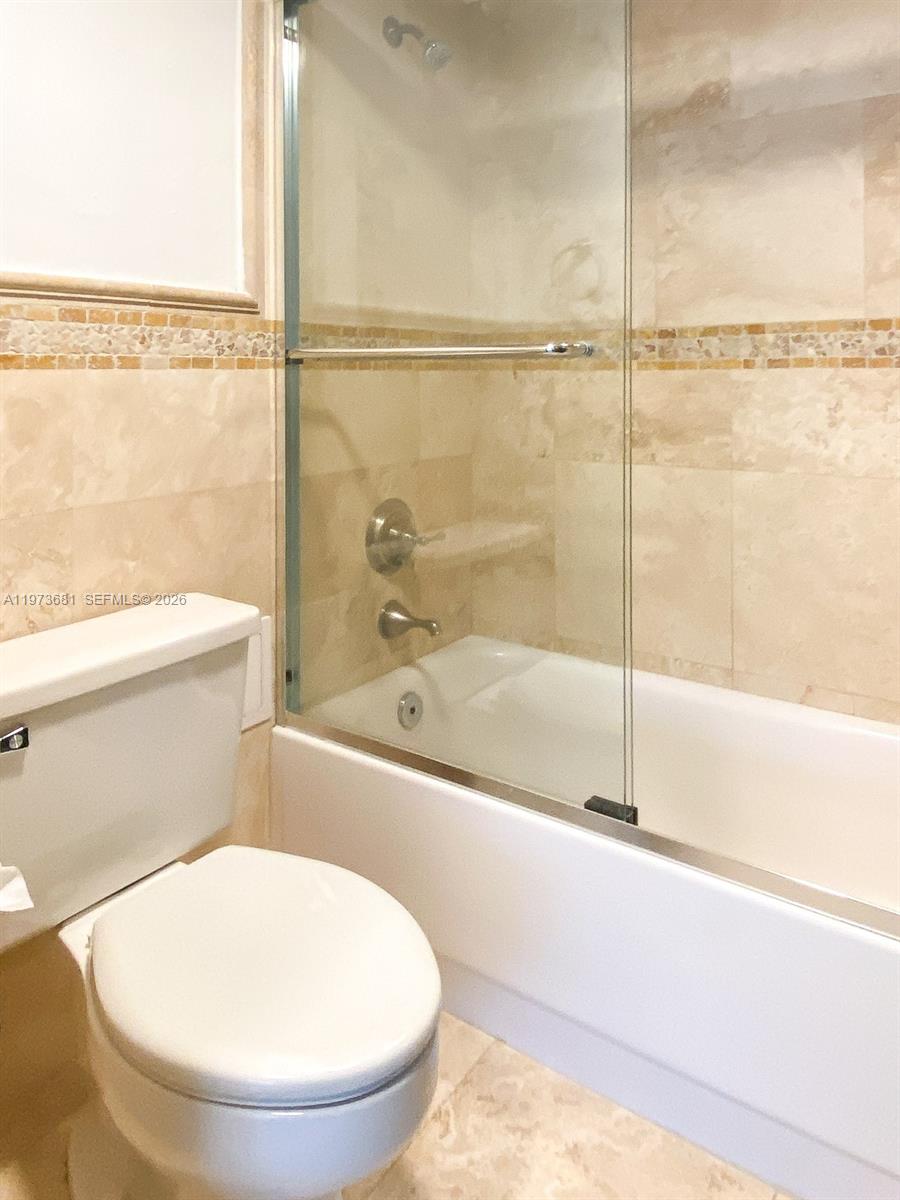 9225 Collins Avenue, Unit 1010 Surfside, FL 33154 - Photo 9 of 25 a bathroom with a toilet and a bathtub