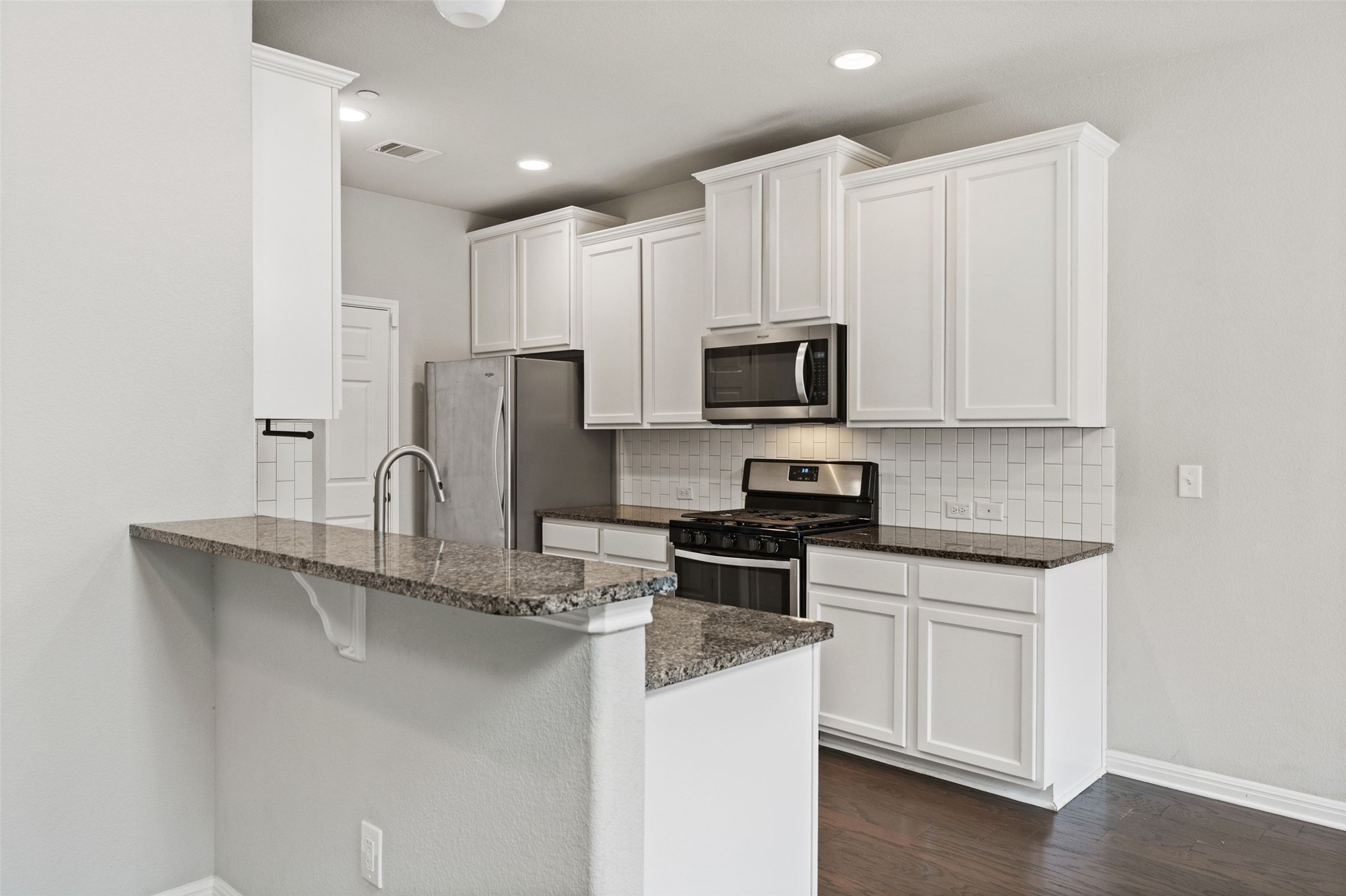 1615 Airedale Road Austin, TX 78748 - Photo 13 of 39 a kitchen with stainless steel appliances granite countertop a sink a stove a refrigerator a microwave and cabinets