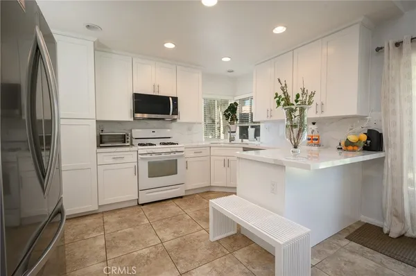 a kitchen with a sink stainless steel appliances and cabinets
