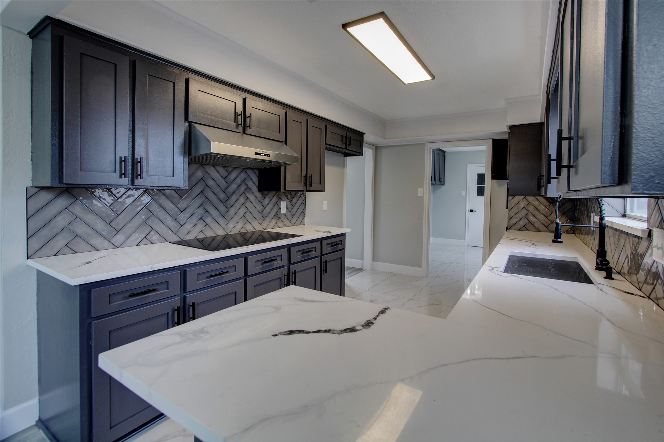 207 Shannondale Lane Spring, TX 77388 - Photo 4 of 27 The kitchen features upgraded countertops and herringbone backspash.