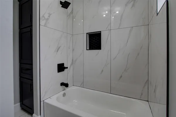 a bathroom with a bathtub and a shower