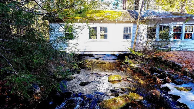 a view of house with yard and swimming pool