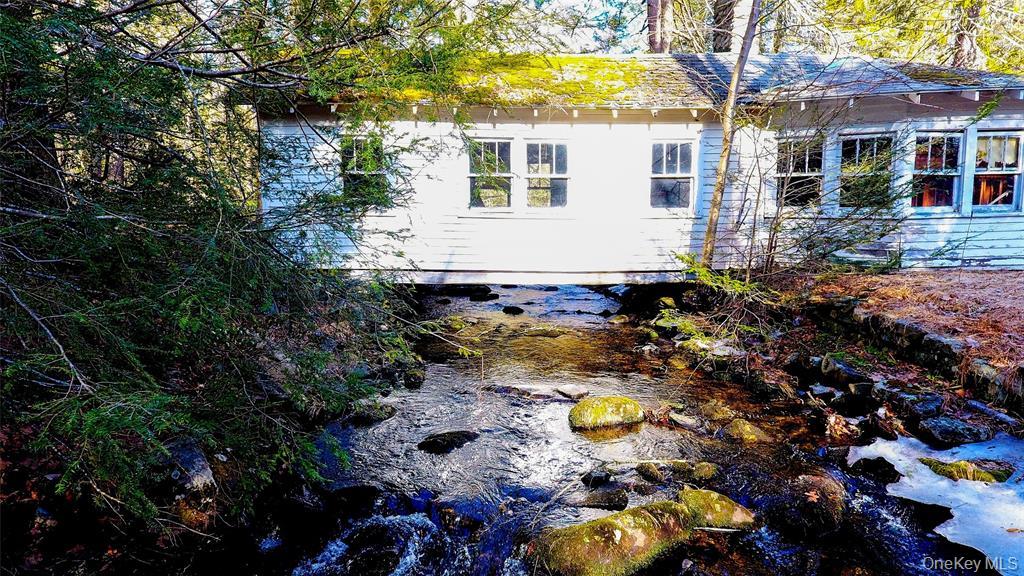 a view of house with yard and swimming pool
