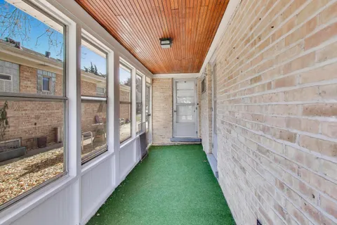 a view of a brick wall next to a building