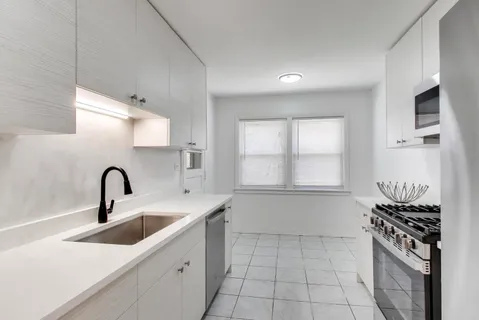 a kitchen with a sink and cabinets