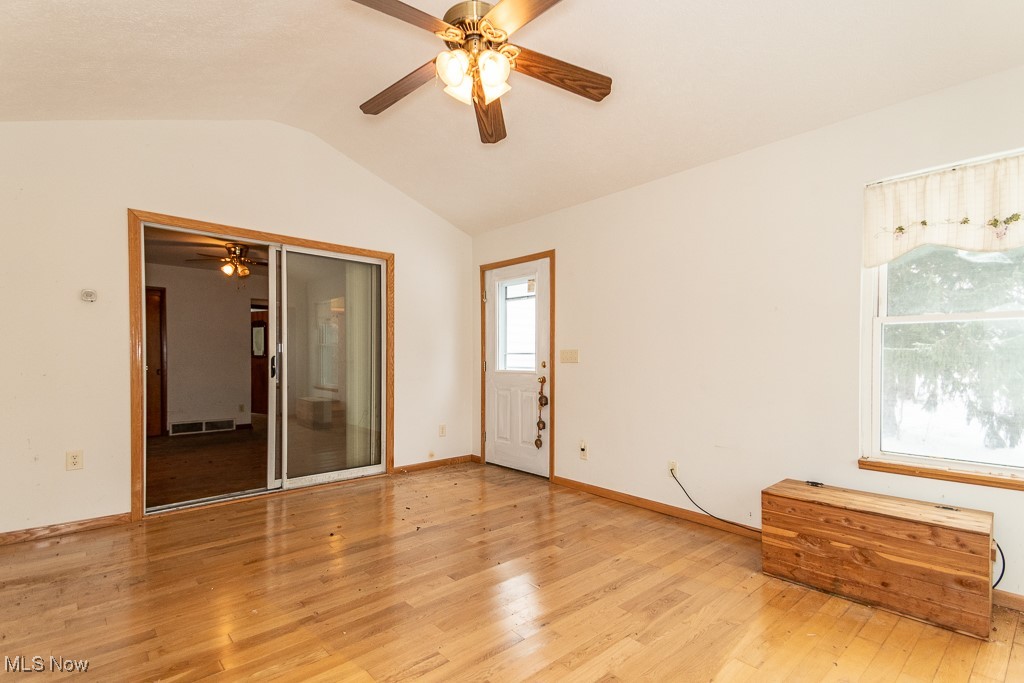 3303 River Road Perry, OH 44081 - Photo 7 of 34 Empty room with light wood-type flooring, vaulted ceiling, and ceiling fan