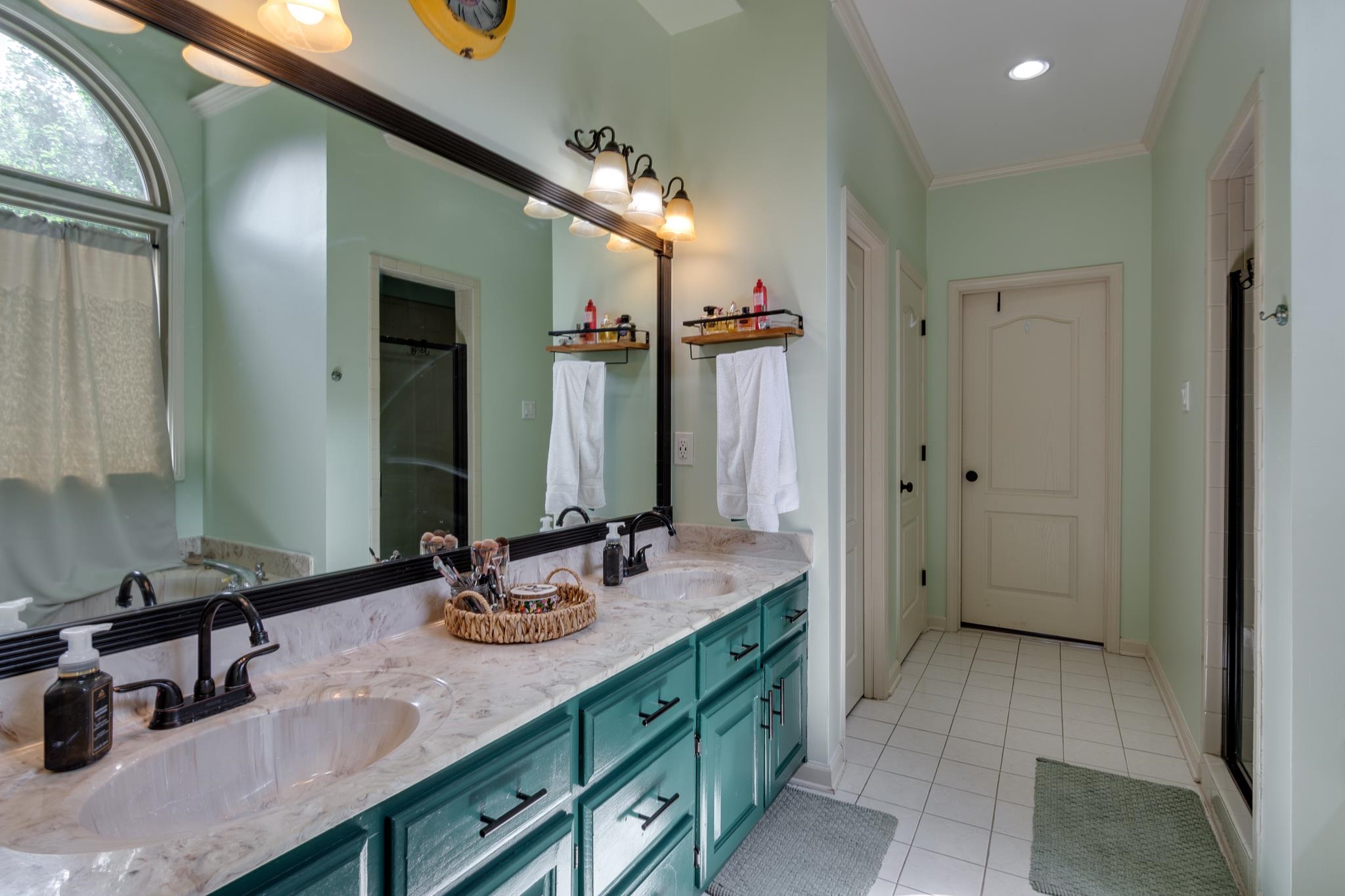 779 Early Earner Cove Collierville, TN 38017 - Photo 15 of 29 Double vanity with undermount sinks, stone countertop, and dark cabinetry