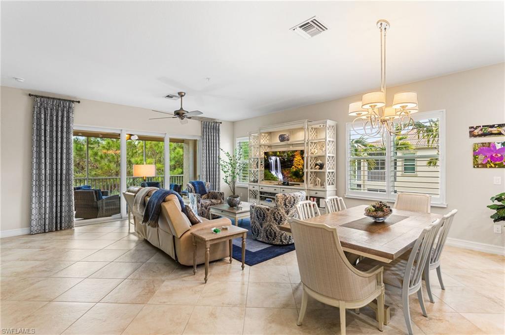 7825 Hawthorne Drive, Unit 2104 Naples, FL 34113 - Photo 11 of 43 a living room with furniture a flat screen tv and a large window